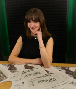 Afton Ford poses with printed editions of the UVU Review